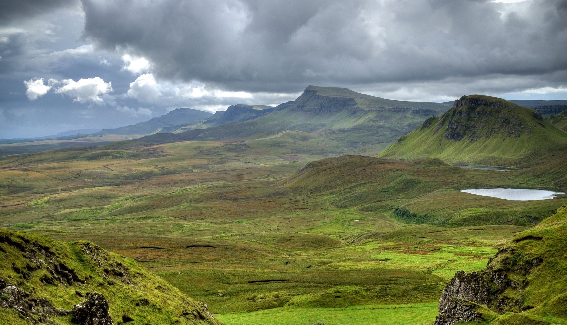 Green hills under cloudy sky