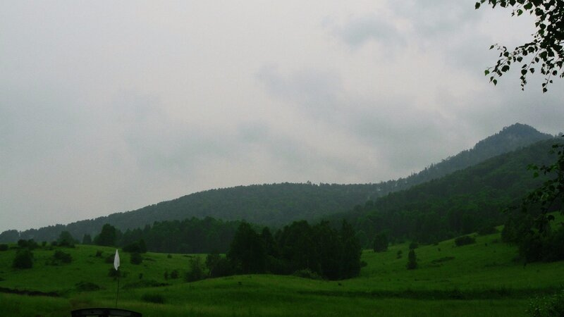 Green hills under cloudy sky