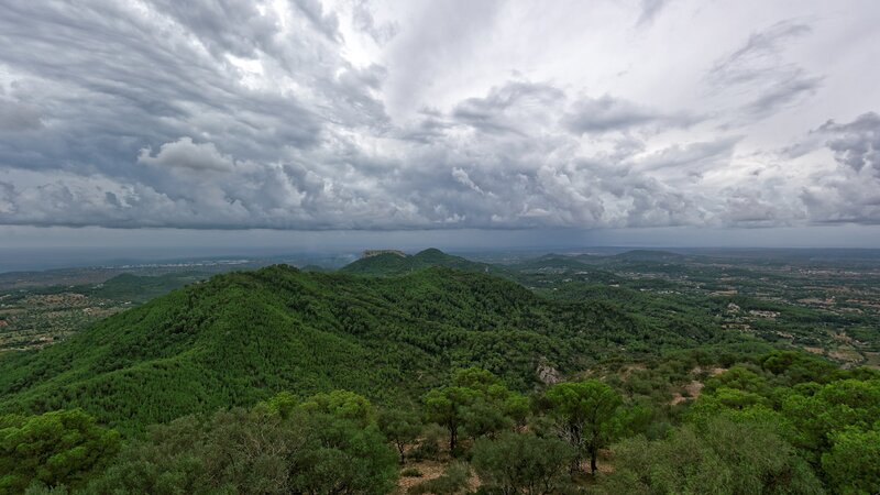 Green Hills under Cloudy Sky — Dramatic, Photograph