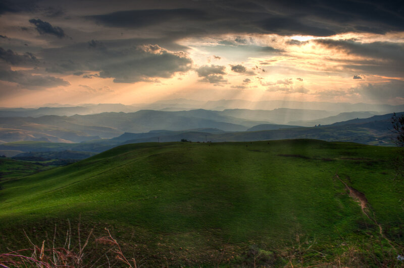 Green Hills under Cloudy Sky — Dramatic, Sunset, Photograph, Clouds, Sunlight
