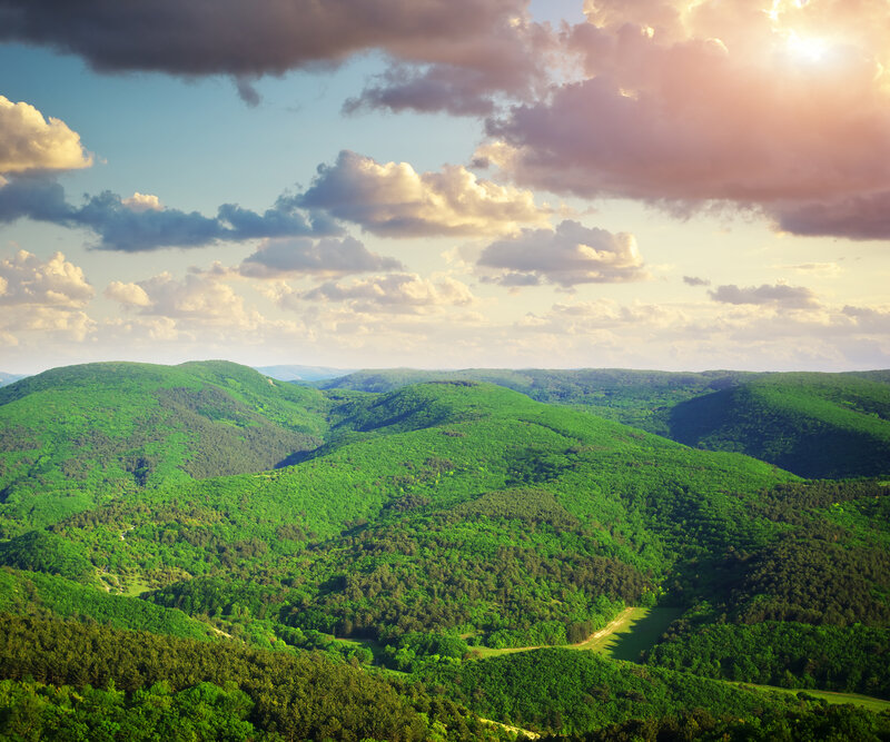 Green Hills under Cloudy Sky — Serene, Sunset