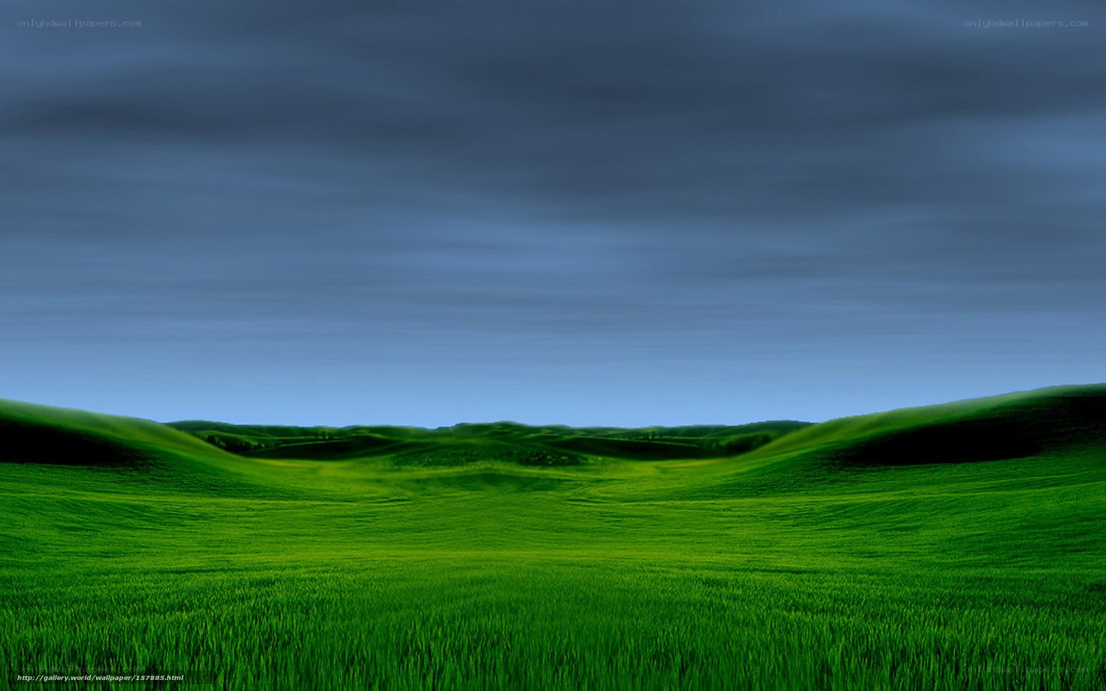 Green hills under dark sky
