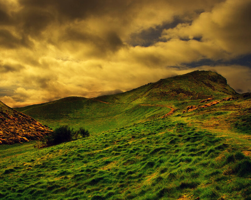 Green hills under golden sky