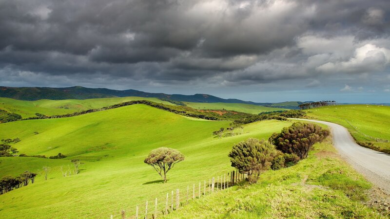 Green hills under stormy sky