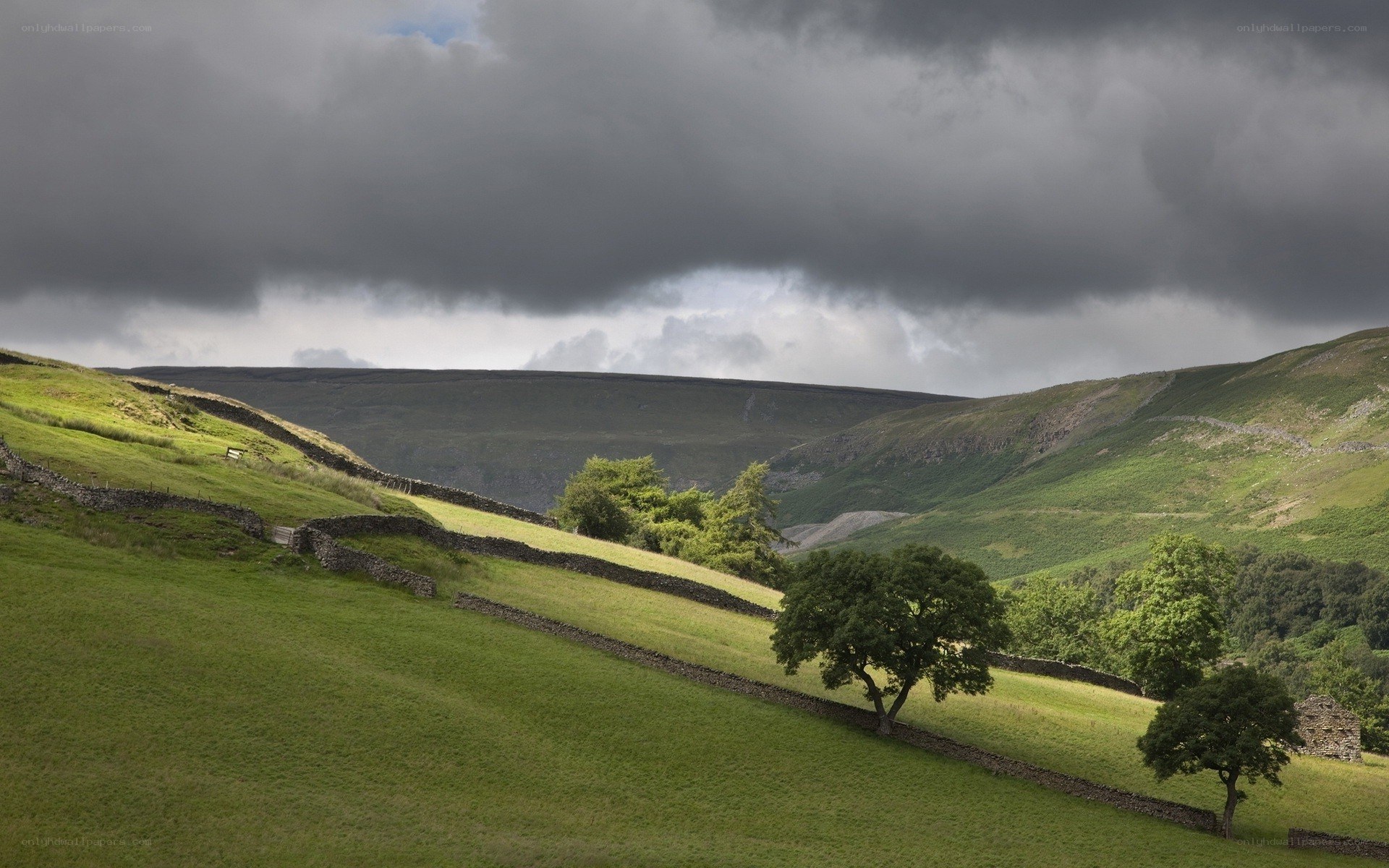 Green hills under stormy sky