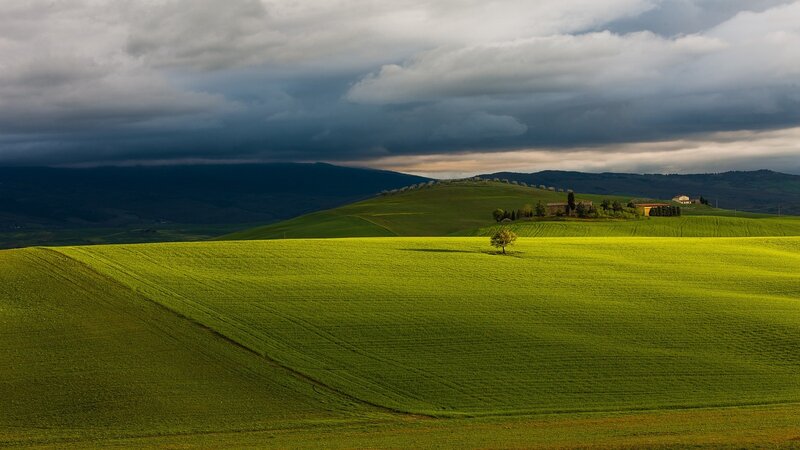 Green hills under stormy sky