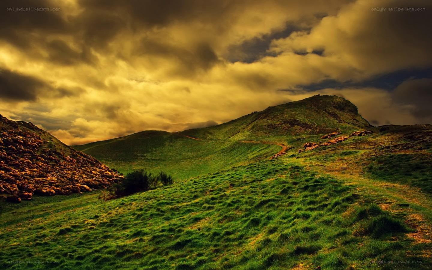 Green hills under stormy sky