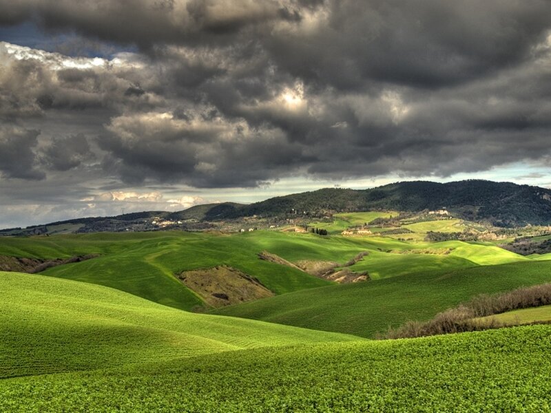 Green hills under stormy sky