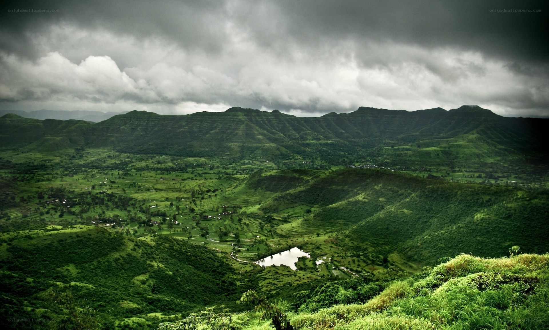 Green hills under stormy sky