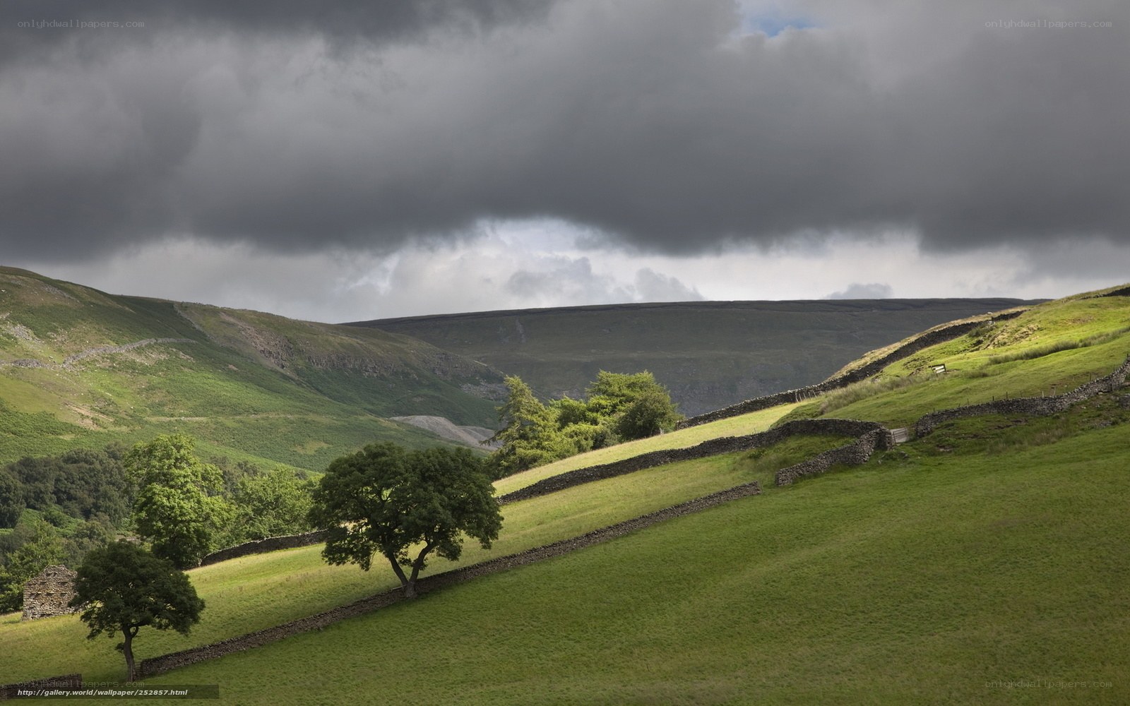 Green hills under stormy sky