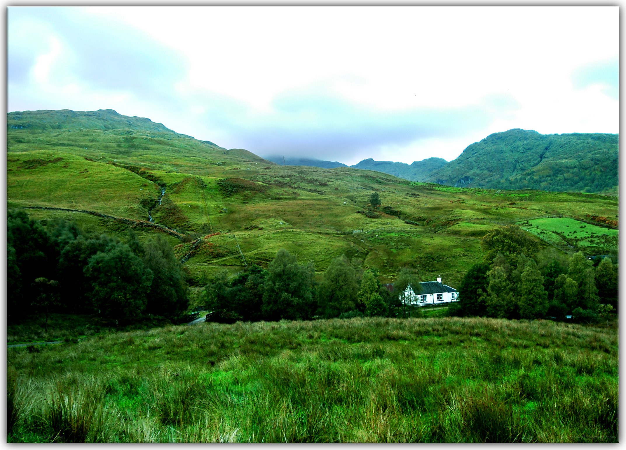 Green hills with a white cottage