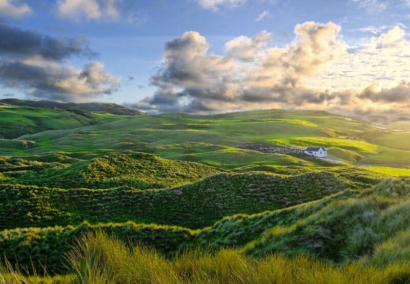 Green hills with a white house