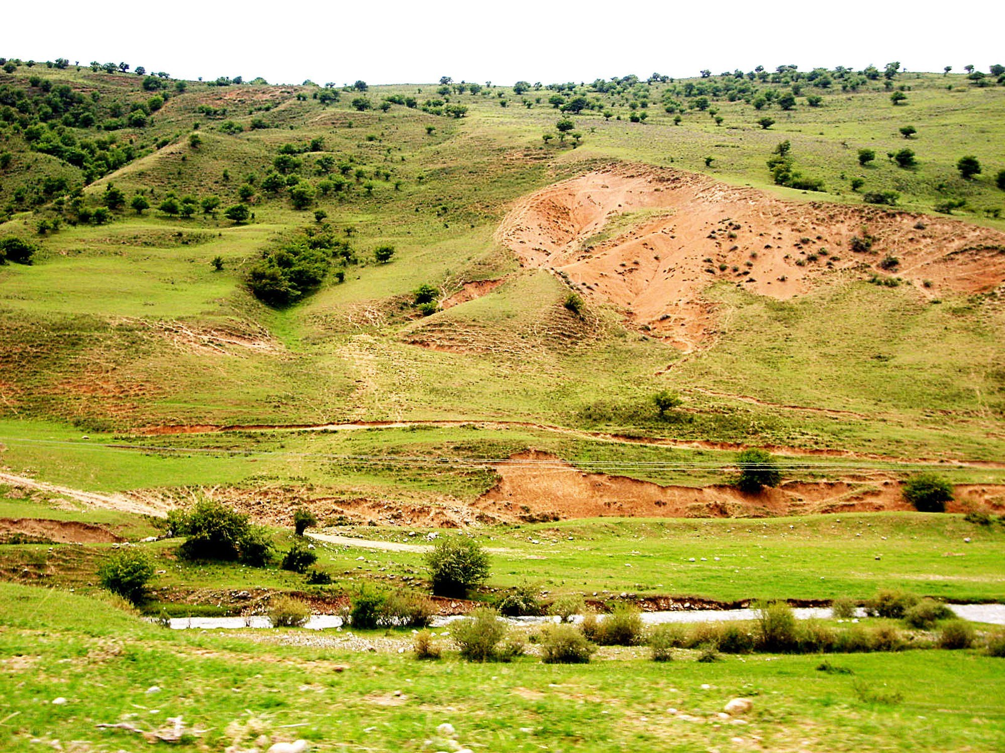 Green hills with erosion