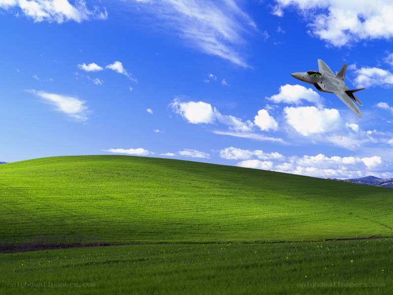 Green hills with fighter jet