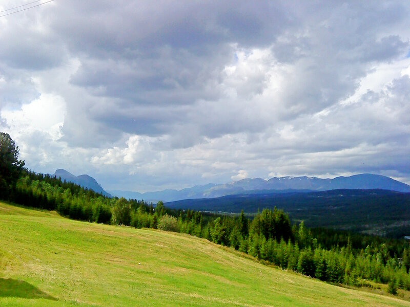 Green Hillside with Mountains — Dramatic