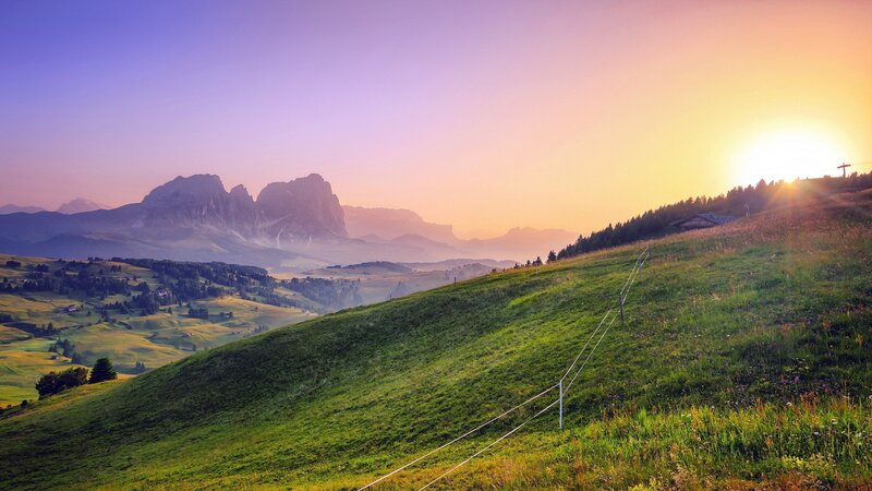 Green Hillside with Mountains — Serene, Sunset