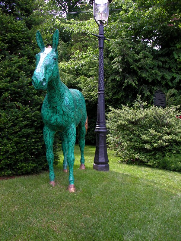 Green horse sculpture in garden