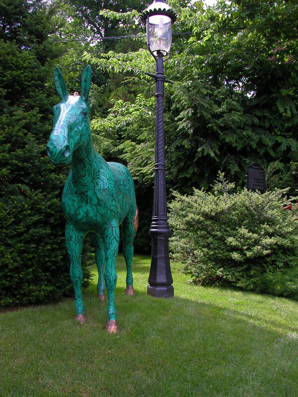 Green horse statue in garden