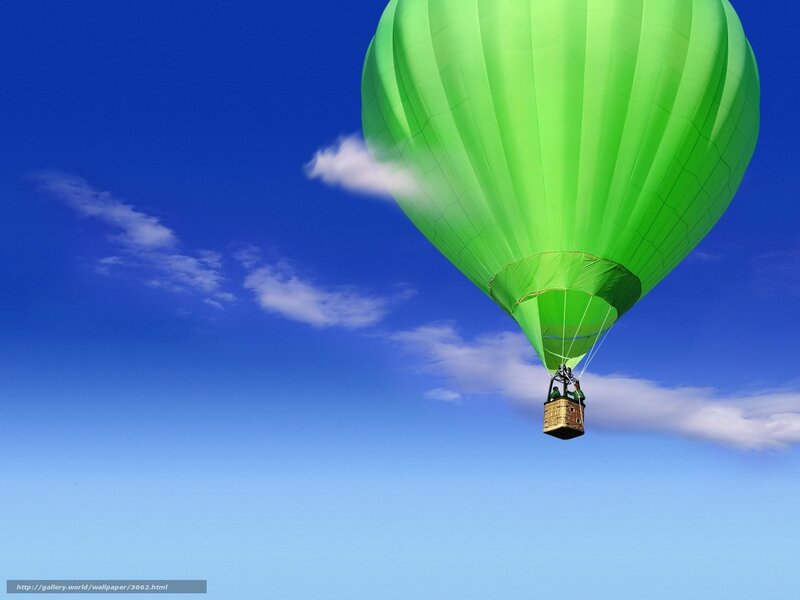 Green hot air balloon in blue sky