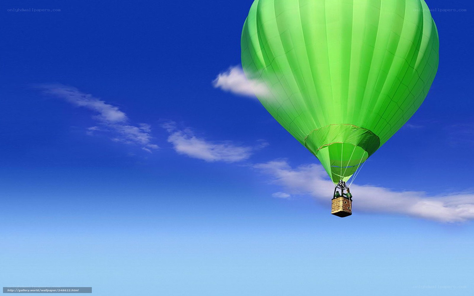 Green hot air balloon in sky