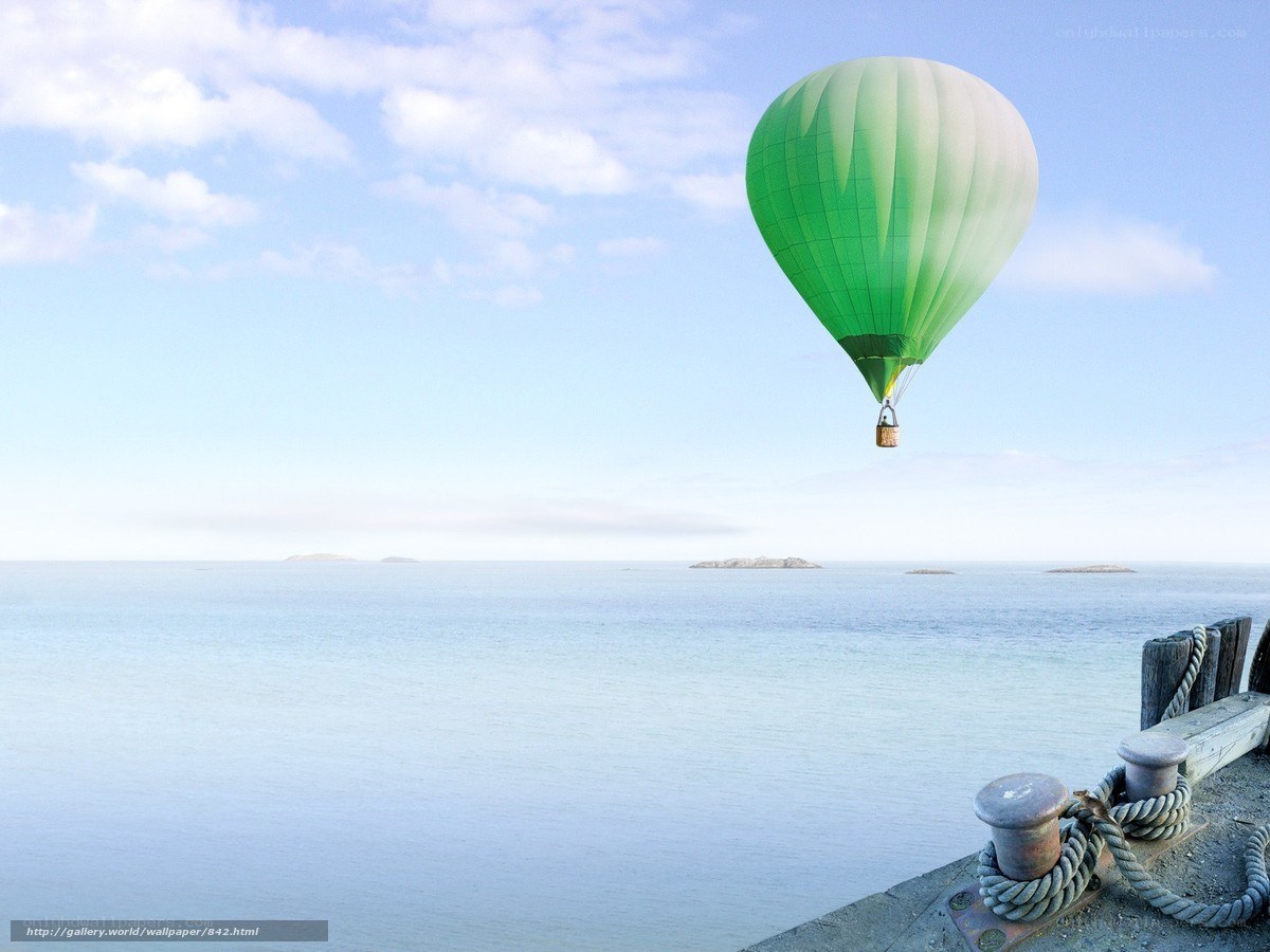 Green hot air balloon over sea