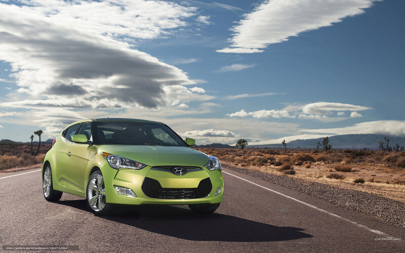 Green Hyundai Veloster on desert road