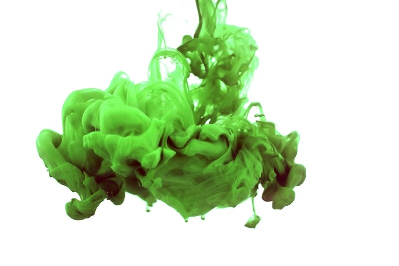 green ink dispersing in water