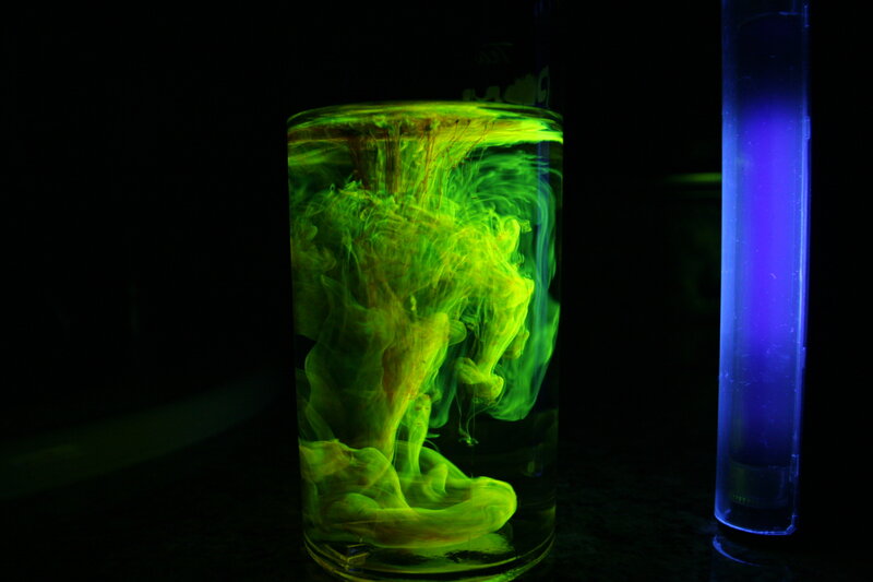 green ink in water under black light
