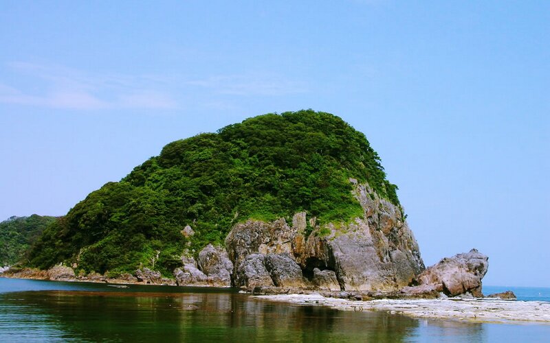 Green island in calm sea