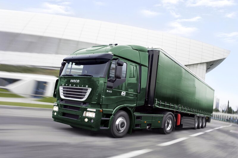 Green Iveco Stralis truck in motion