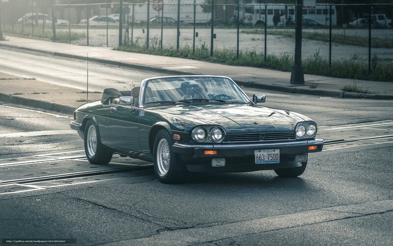 Green Jaguar convertible on street