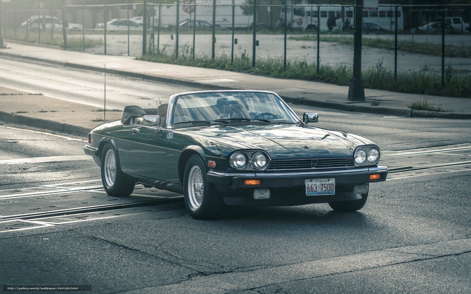 Green Jaguar convertible on street