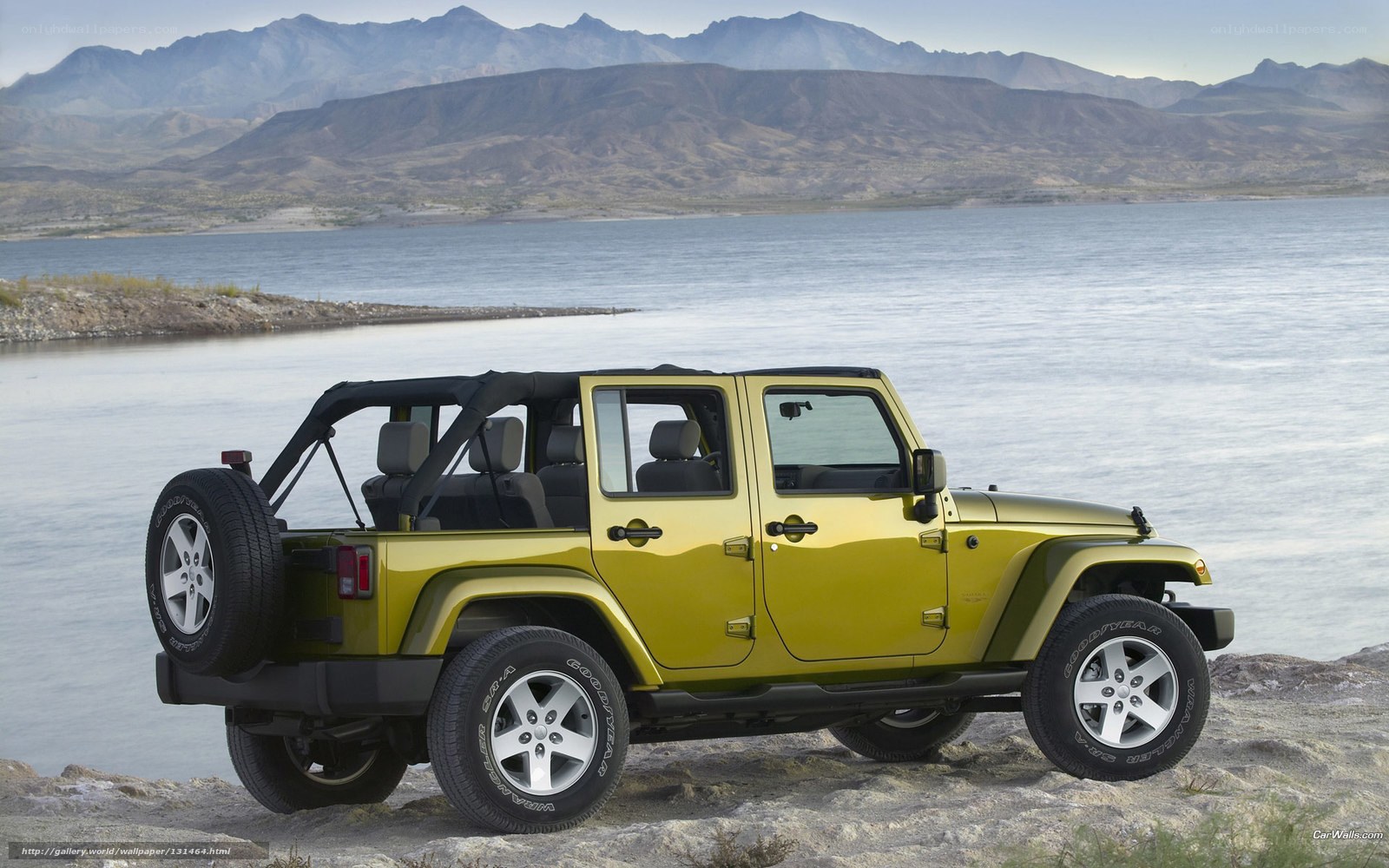 Green Jeep near a lake