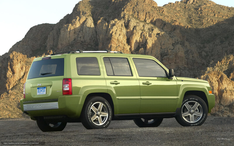 Green Jeep Patriot in desert