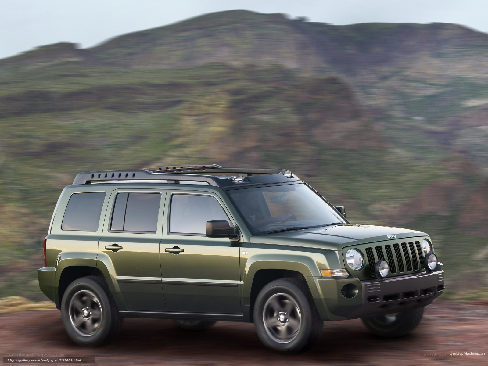 Green Jeep Patriot in motion