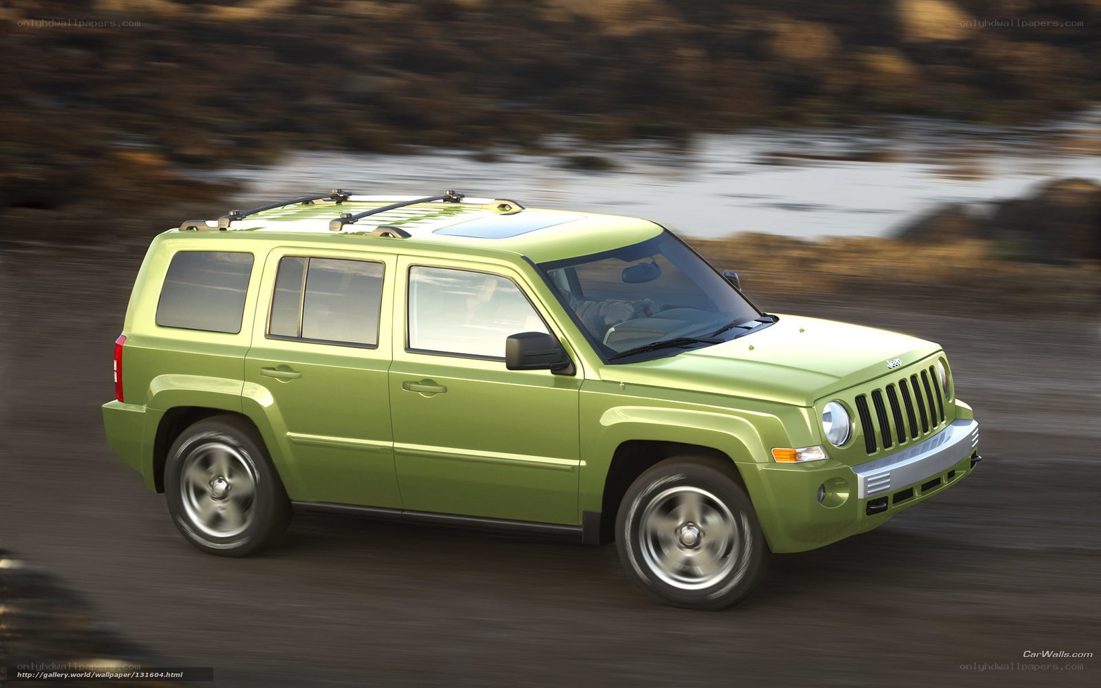 Green Jeep Patriot in motion