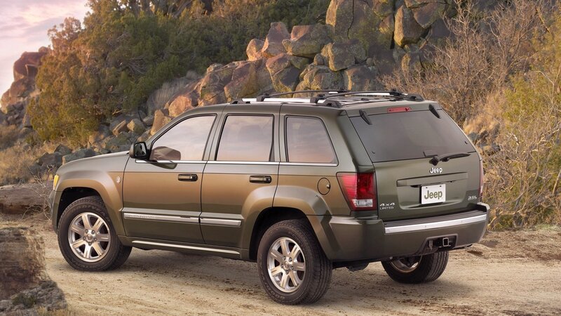 Green Jeep SUV in rocky landscape