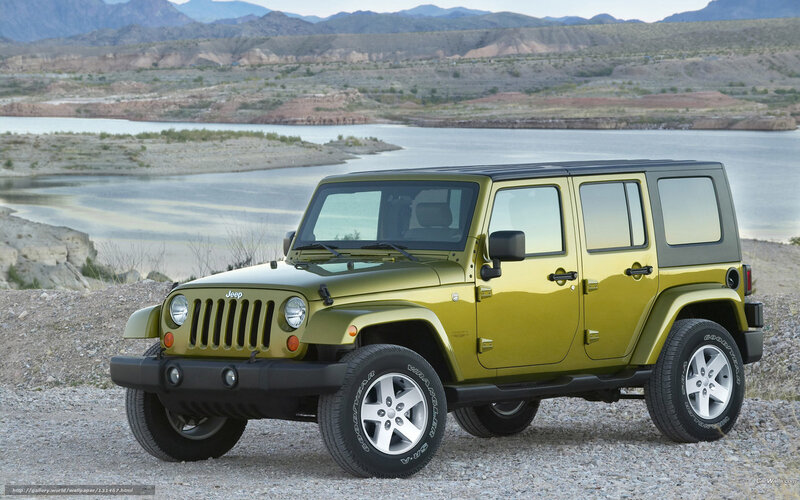 Green Jeep Wrangler by a lake