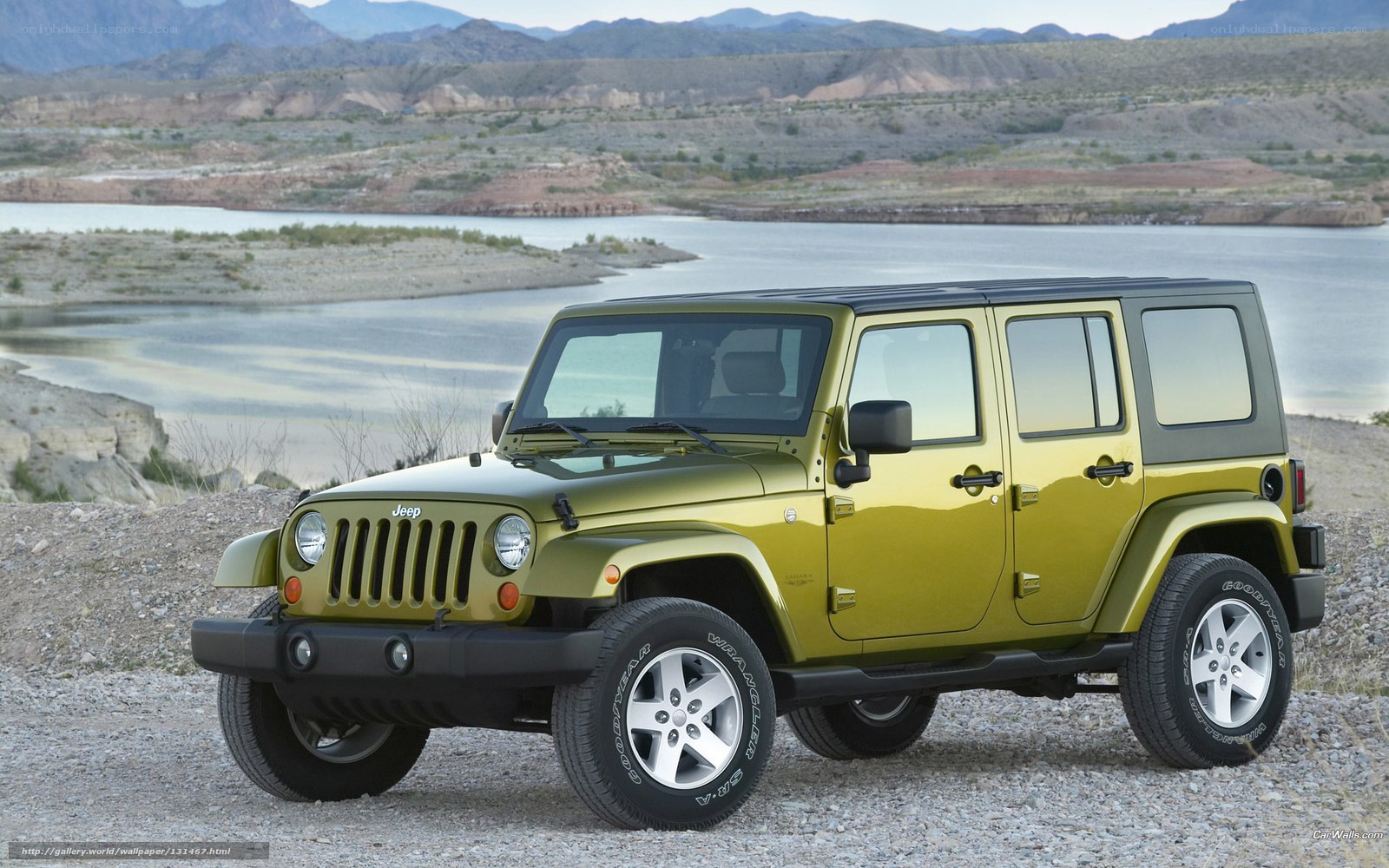 Green Jeep Wrangler by a lake