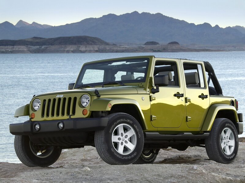 Green Jeep Wrangler by the lake