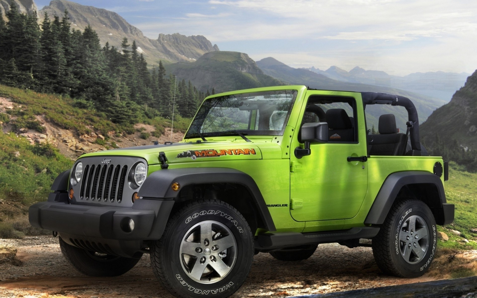 Green Jeep Wrangler in mountains