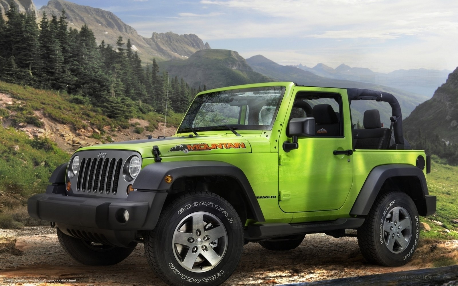 Green Jeep Wrangler in mountains