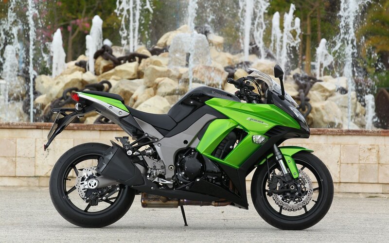 Green Kawasaki motorcycle at fountain