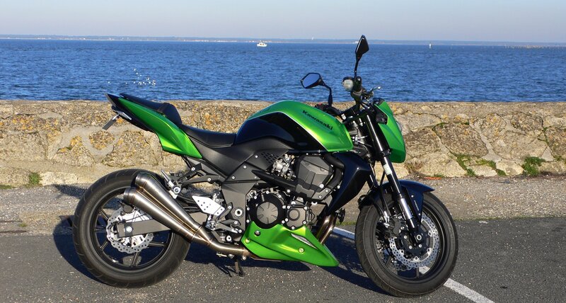 green kawasaki motorcycle by the sea