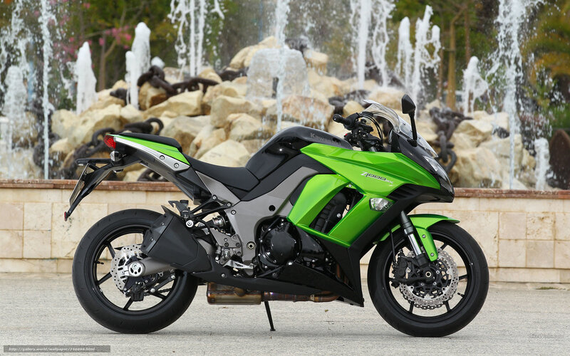 Green Kawasaki motorcycle in front of fountain