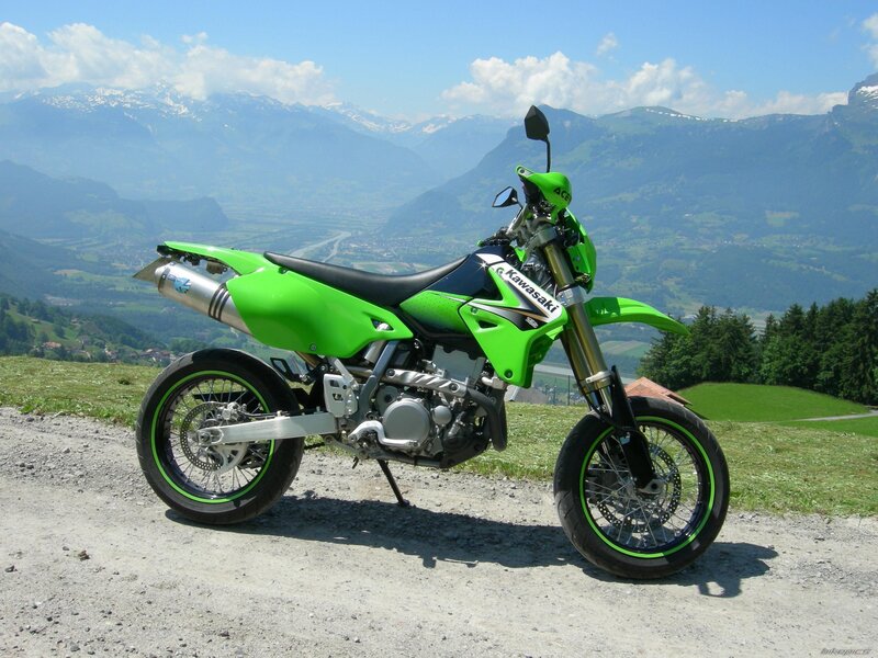 Green Kawasaki motorcycle on mountain road