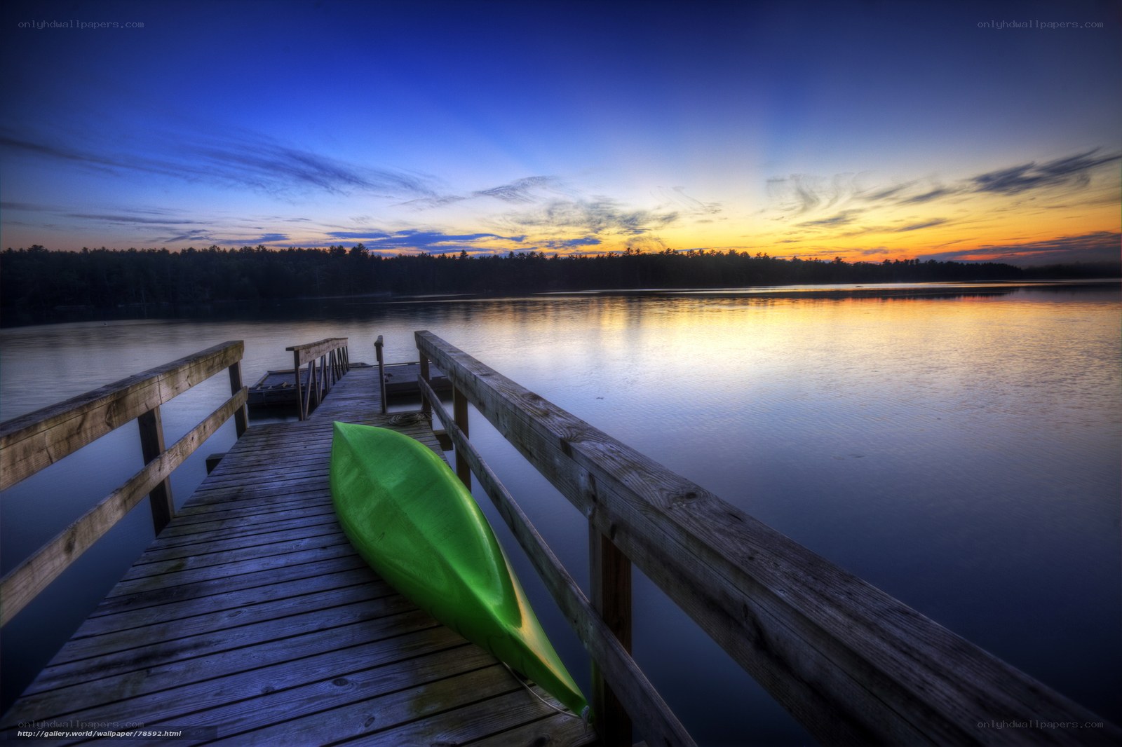 Green kayak at sunset dock