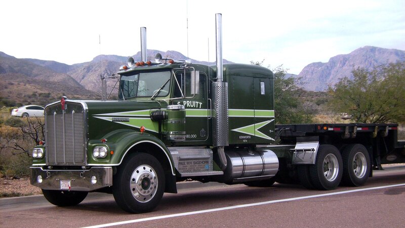 green kenworth truck on road