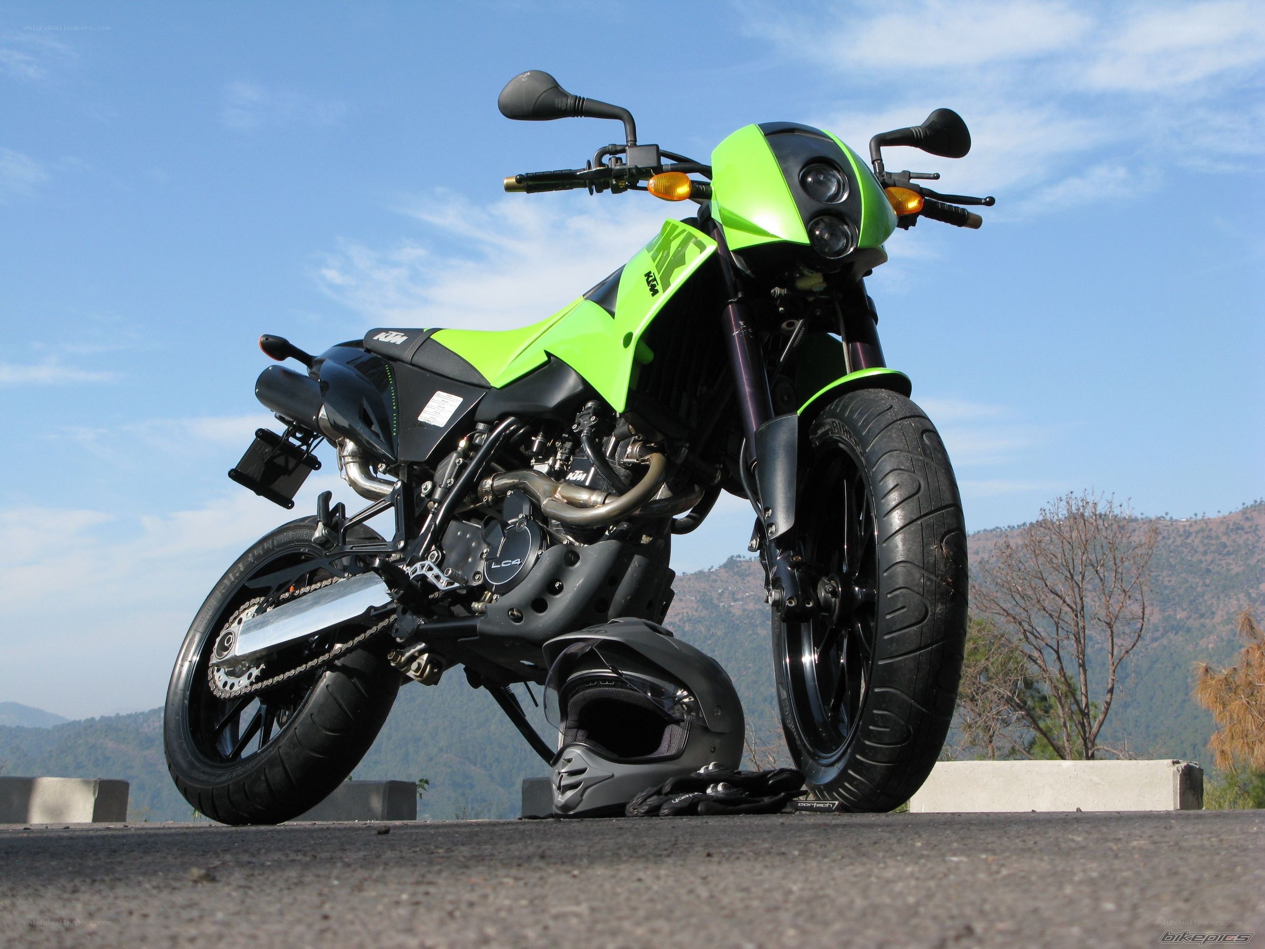 green ktm motorcycle on road