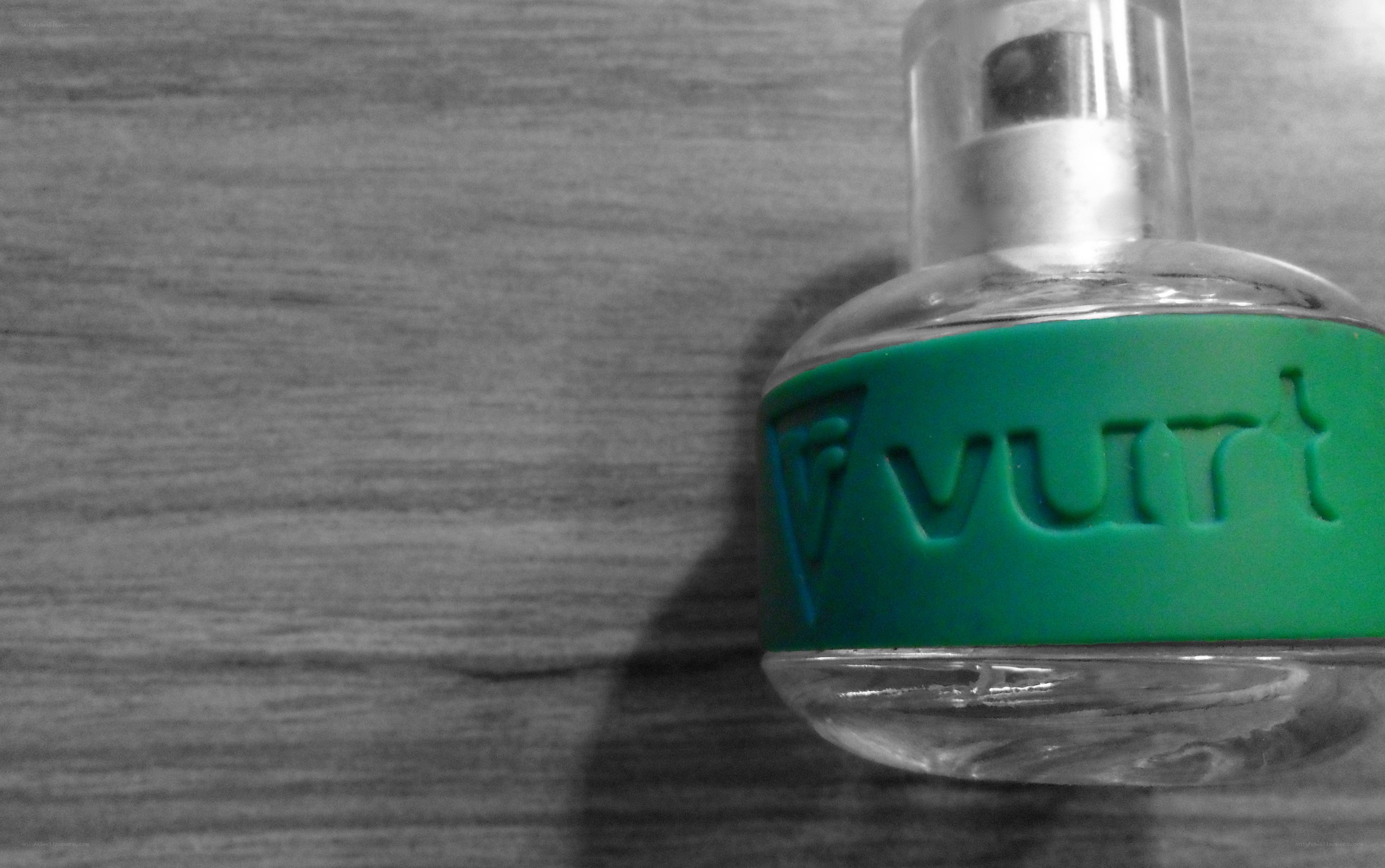 green-labeled bottle on wood